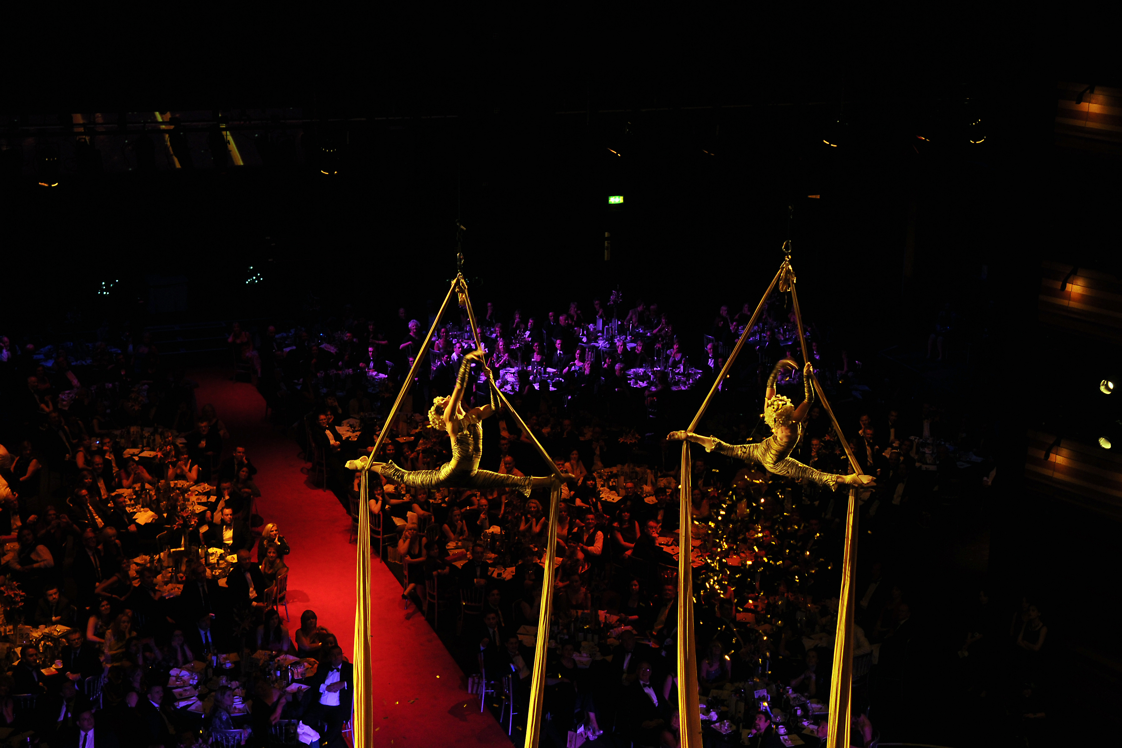 Gold Dust performing an aerial act on gold silks at the Arts & Business Cymru Awards at Wales Millennium Centre 