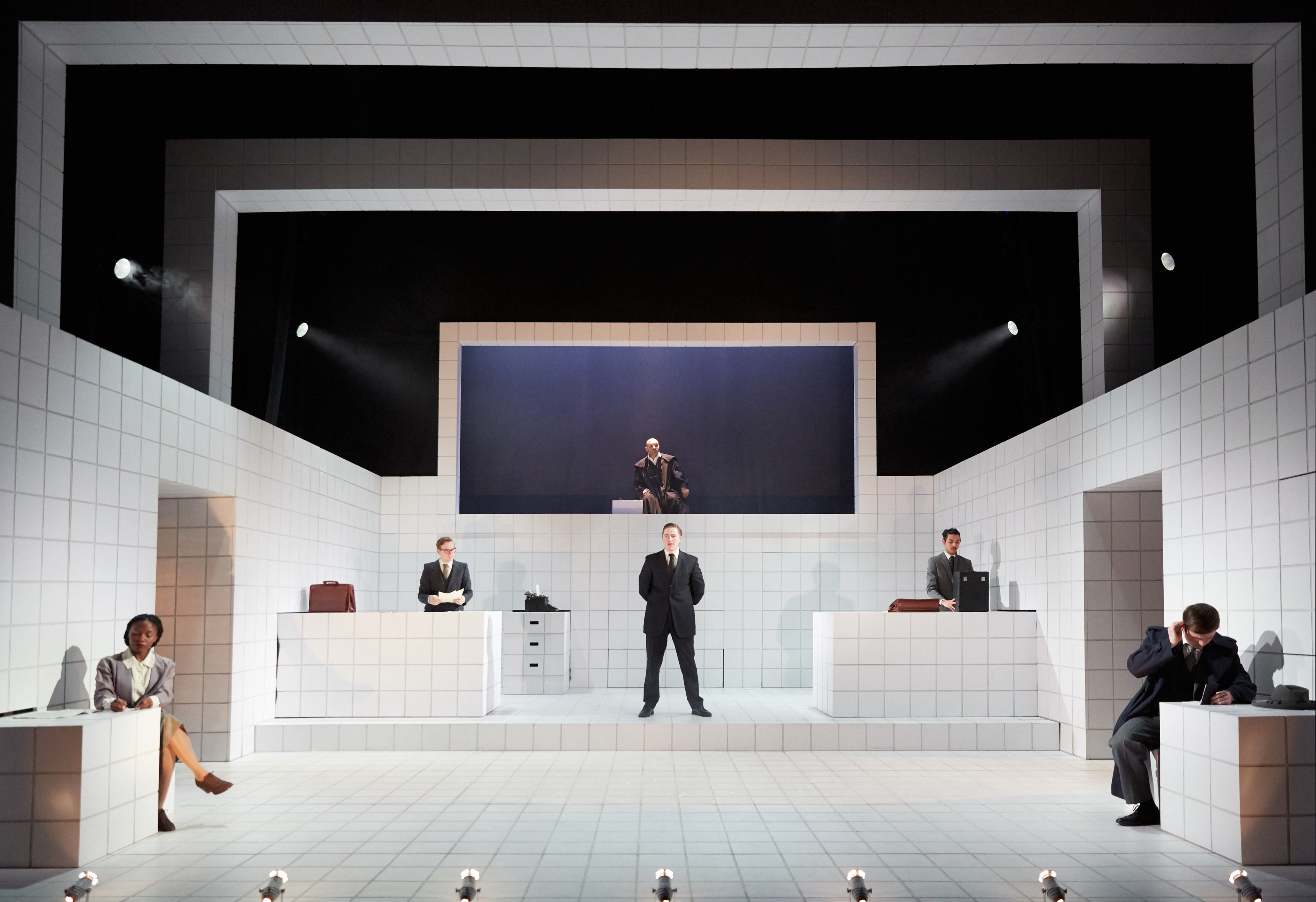 Six actors dressed in business attire in Royal Welsh College of Music & Drama’s ‘Machinal’. Photo by Mark Douet