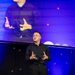 A student performing a monologue from a presentation stage