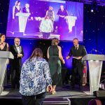 Actor Julian Lewis Jones presenting the Arts, Business & the Community Award to people accepting it on behalf of Cardiff Harbour Authority